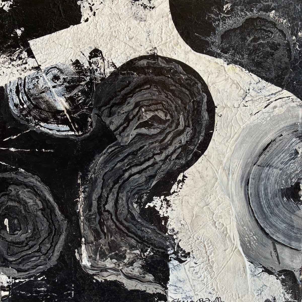 Abstract black, white, and gray textured painting with organic circular and flowing forms, thick impasto brushstrokes, and a small artist signature at the bottom right.